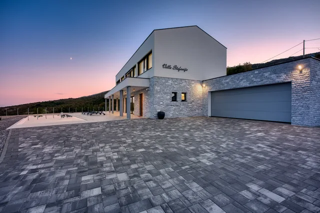 Driveway and side façade of Villa Stefanija at dusk