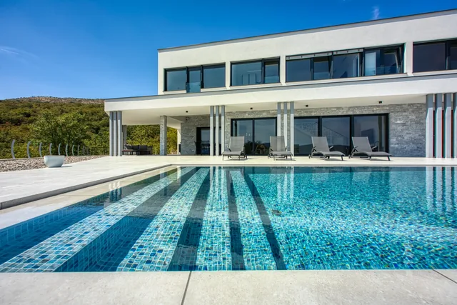 View across the pool towards the villa façade