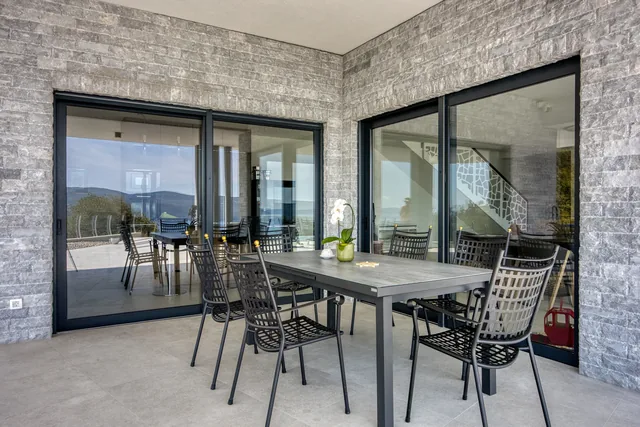 Covered dining terrace beside the glass doors