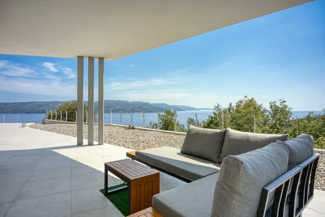 Outdoor seating on the covered terrace overlooking the sea