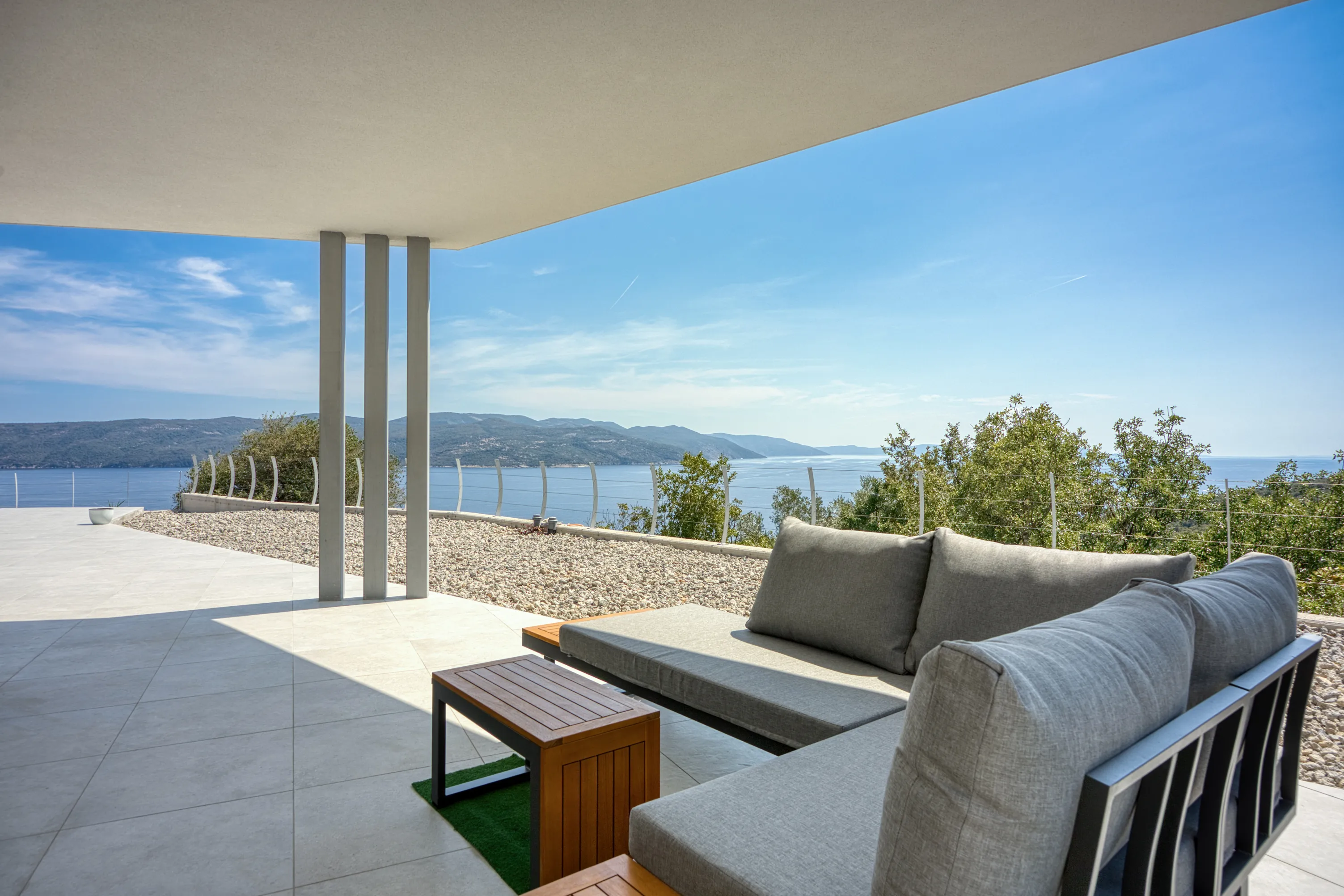 Outdoor seating on the covered terrace overlooking the sea