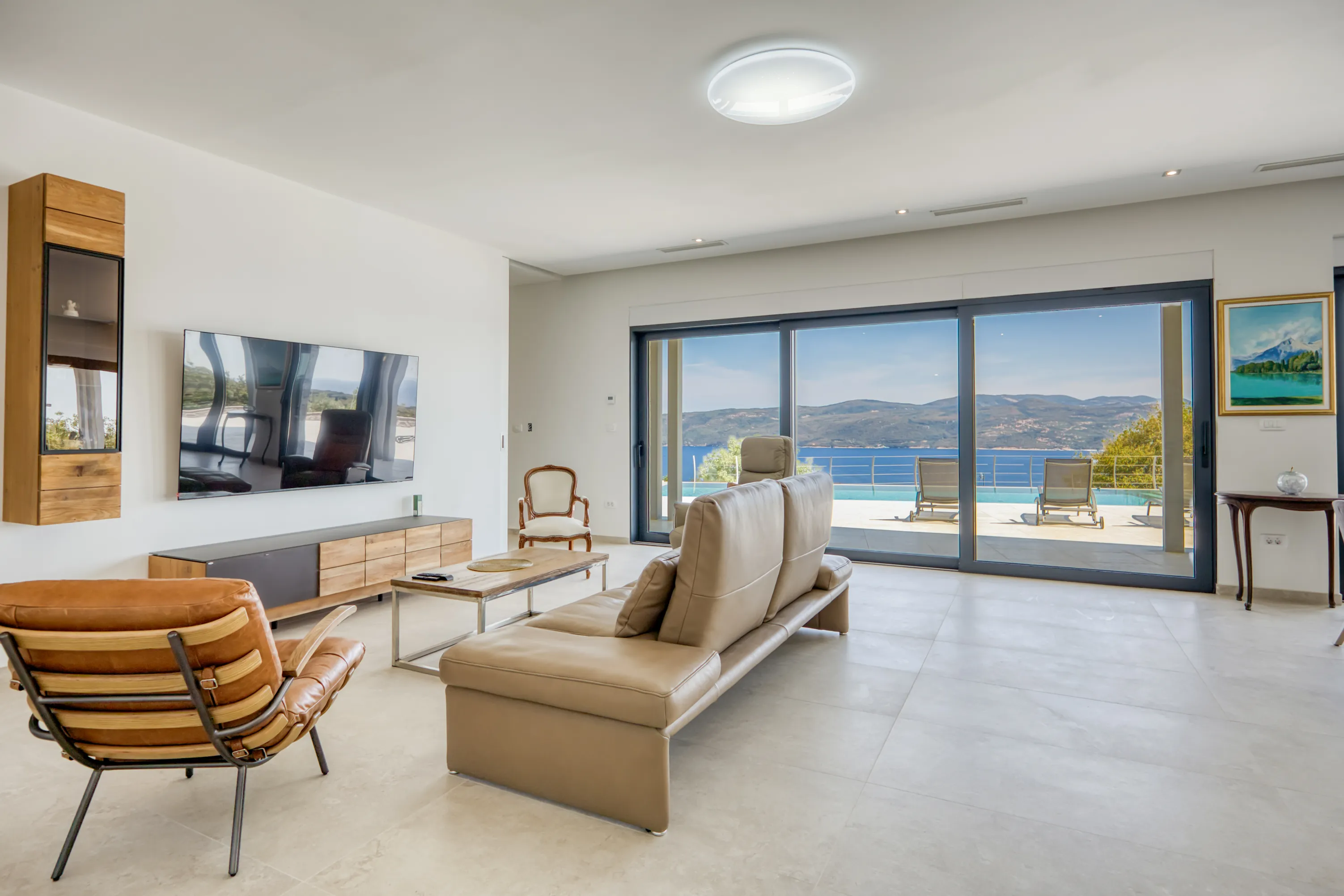 Living room with large glass doors and views of the sea