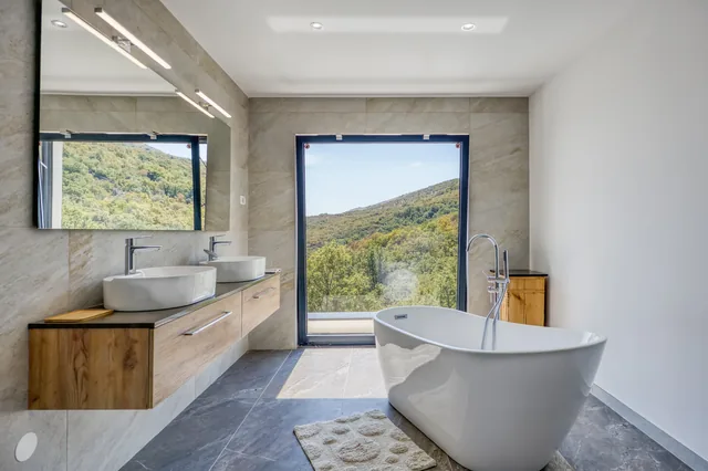 Bathroom with a freestanding bath and views of the greenery