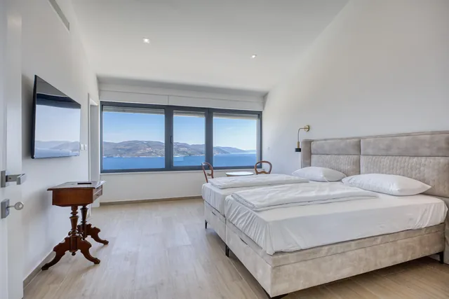 Bedroom with a large window overlooking the sea
